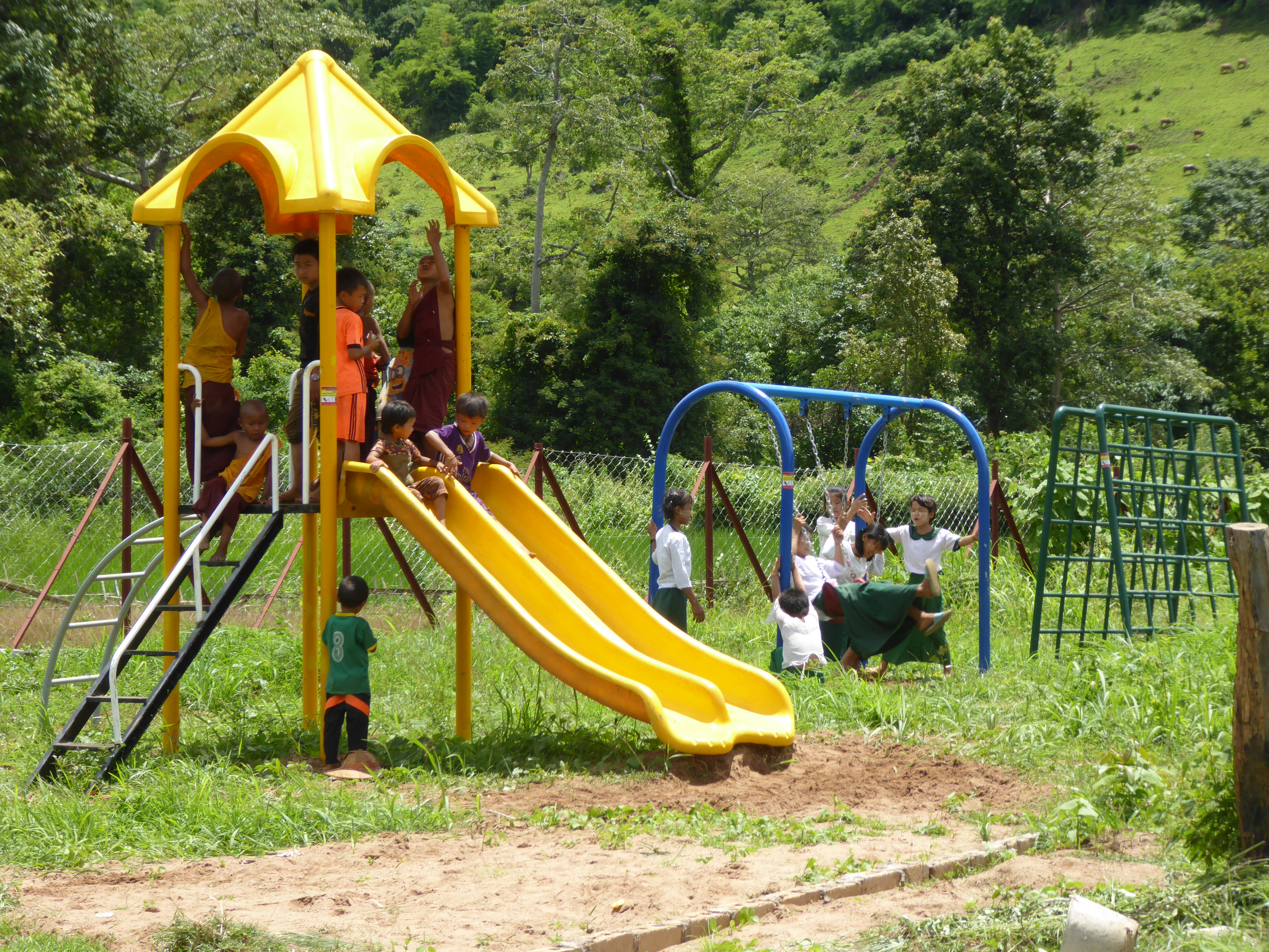 The children of the village are happy about the new playground of the school 