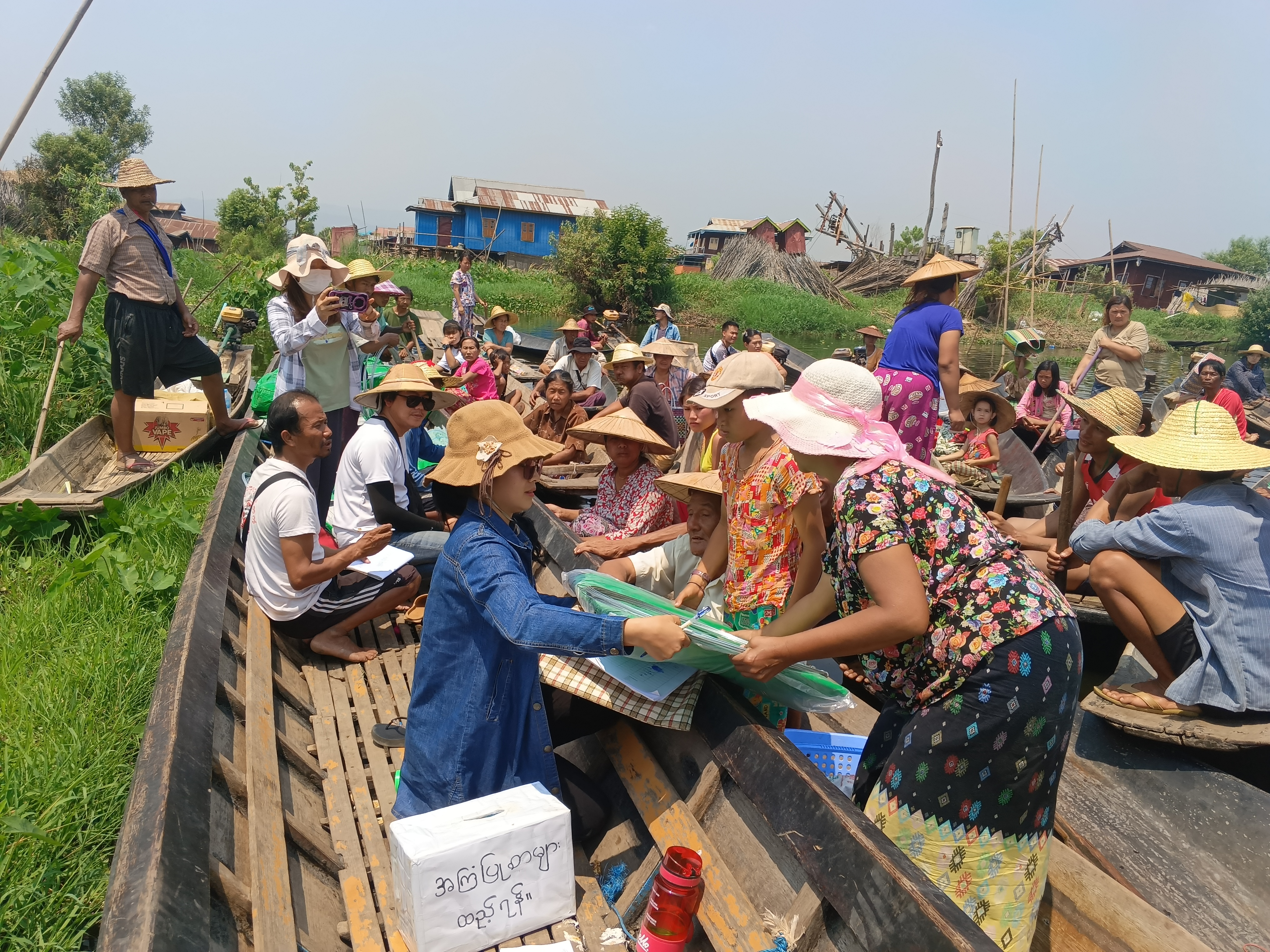 Einsatzkräfte verteilen Hygienepakete an Betroffene des Erdbebens in Myanmar. Alle sitzen/stehen in Booten.